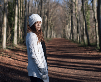 Image of girl looking back from forest