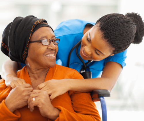 Female nurse hugging female patient